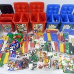 カラフルなレゴが並んでいる。赤や青のバケツや、沢山のLEGOブロックやフィグがある。